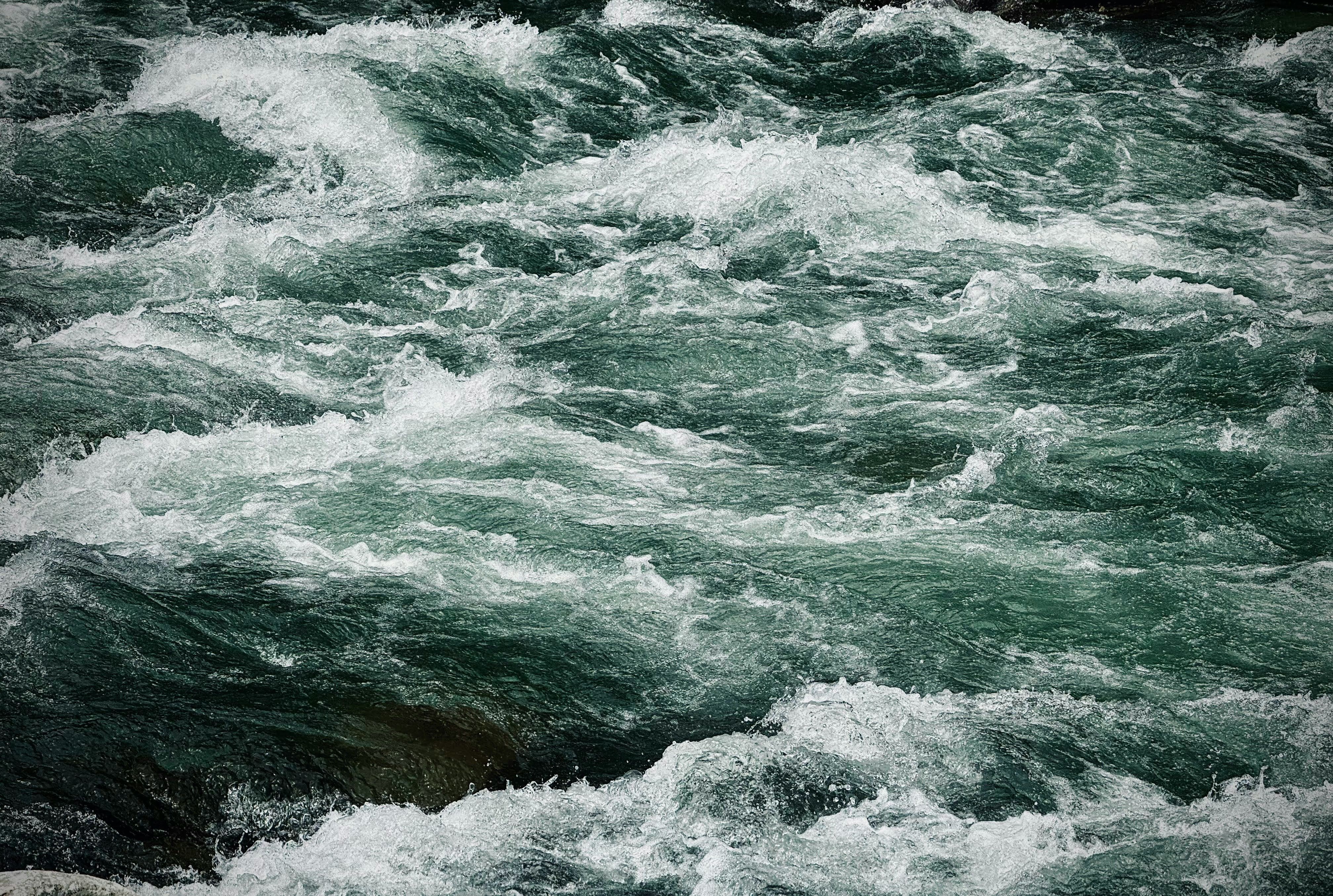 Strong river currents and flowing water surface