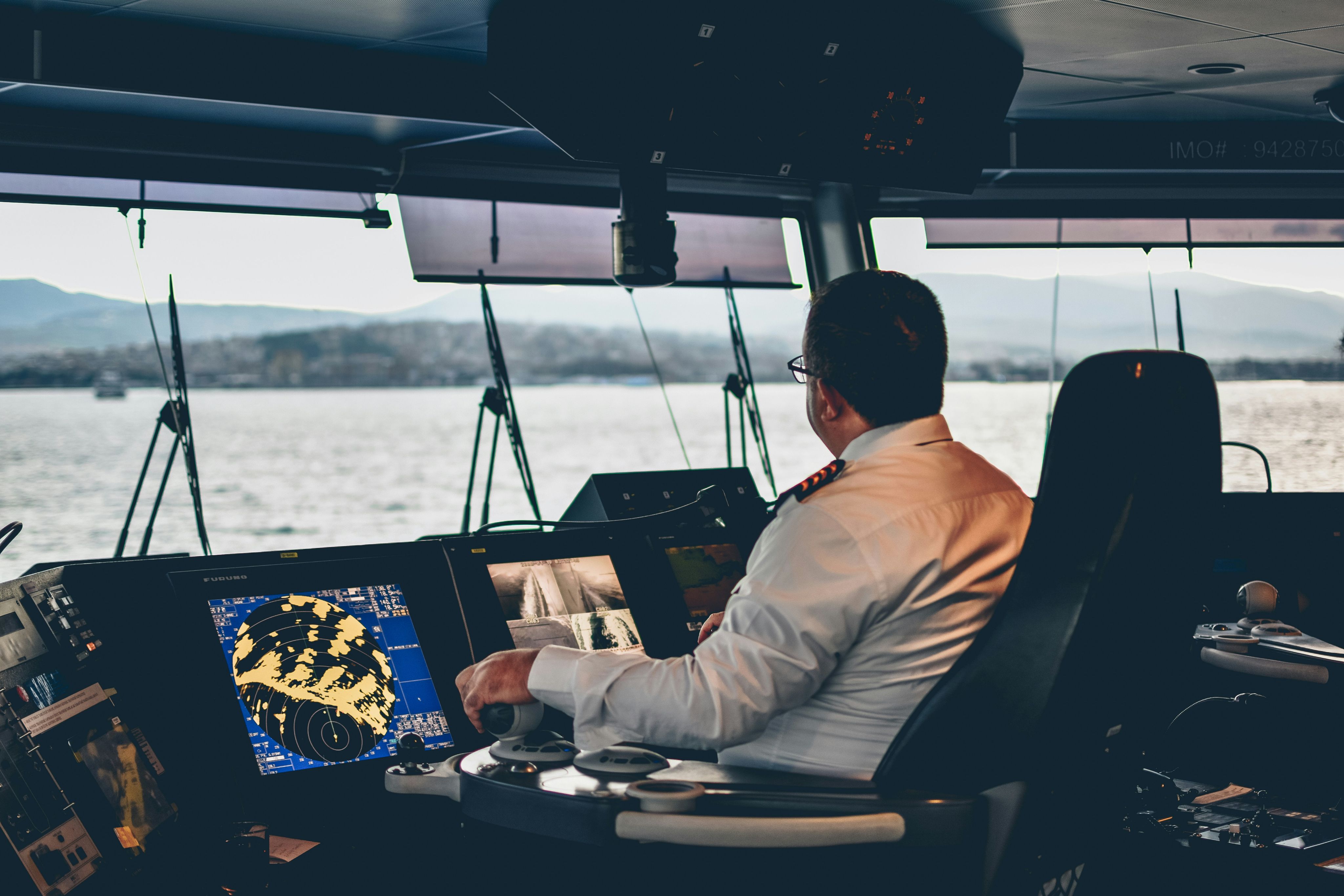 Crew member navigating vessel bridge